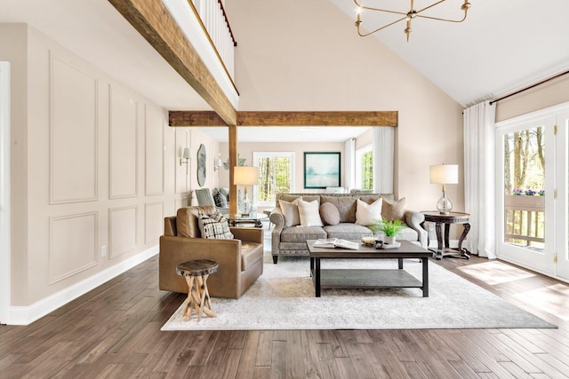 living room featuring baseboards, wood finished floors, a notable chandelier, and high vaulted ceiling