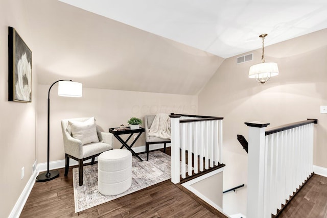 sitting room featuring visible vents, wood finished floors, and an upstairs landing