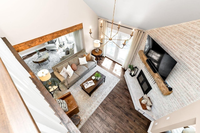 living room featuring a chandelier, wood finished floors, and lofted ceiling