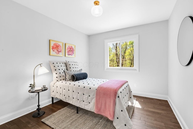bedroom featuring baseboards and hardwood / wood-style floors