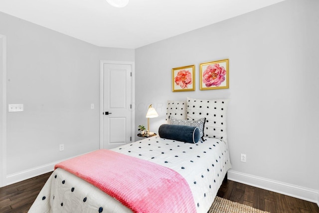 bedroom featuring baseboards and dark wood-style floors
