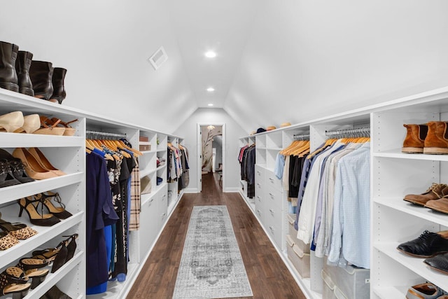 spacious closet with visible vents, wood finished floors, and lofted ceiling