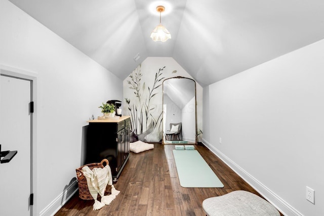 interior space with baseboards, dark wood finished floors, and lofted ceiling