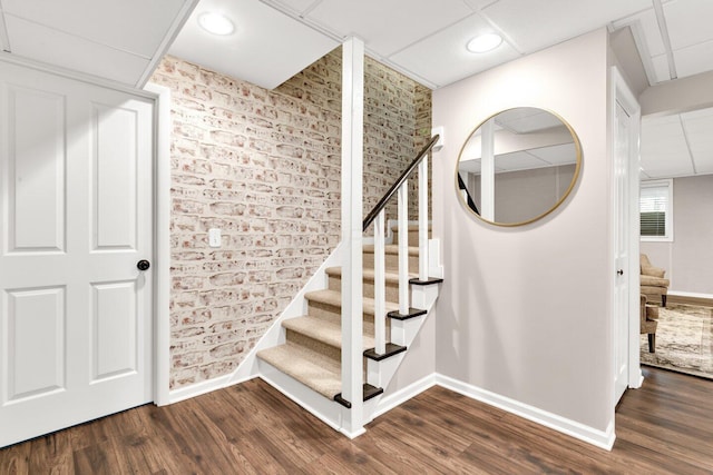 stairs featuring baseboards and wood finished floors