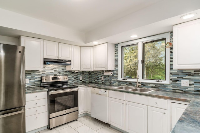 kitchen with white cabinets, a sink, stainless steel appliances, backsplash, and under cabinet range hood