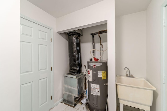 utility room featuring a sink and electric water heater