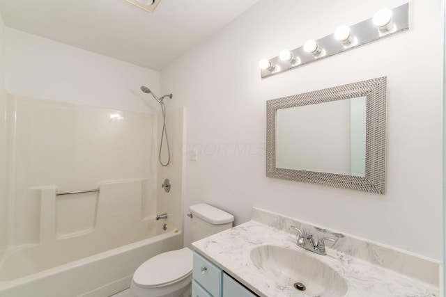 bathroom featuring vanity, bathtub / shower combination, and toilet