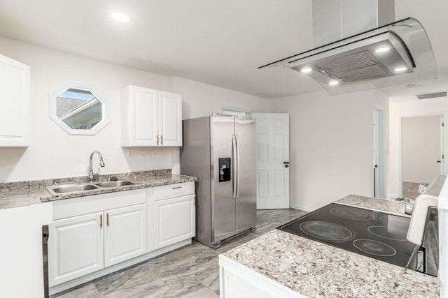 kitchen with visible vents, white cabinetry, stainless steel fridge with ice dispenser, a sink, and range with electric cooktop