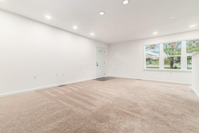 spare room featuring recessed lighting, baseboards, and carpet
