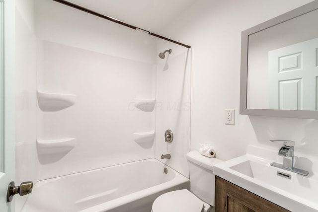 bathroom featuring vanity, shower / bathtub combination, and toilet