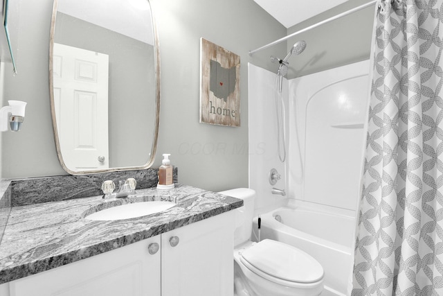 bathroom with vanity, shower / bath combo with shower curtain, and toilet