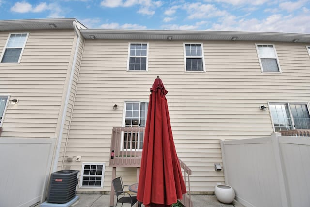 back of house with fence, cooling unit, and a patio area