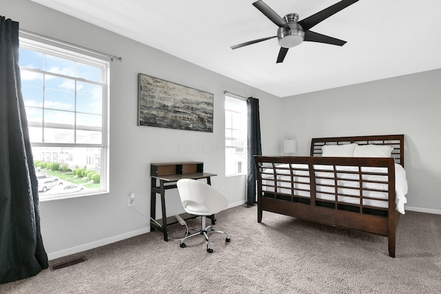 bedroom with carpet floors, baseboards, and visible vents