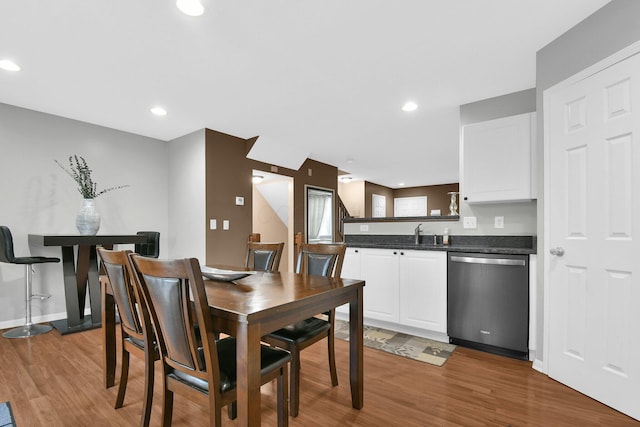 dining area with recessed lighting, baseboards, and wood finished floors