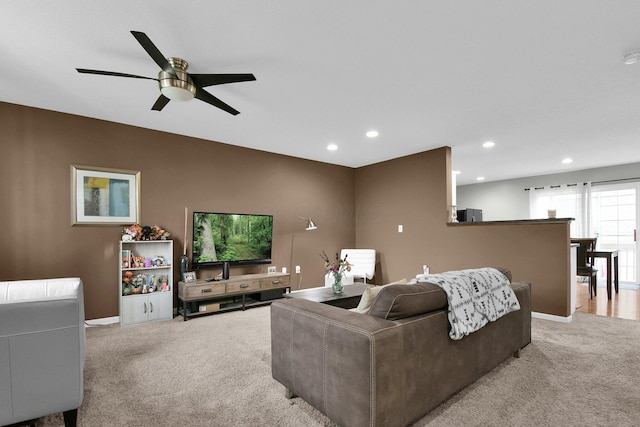 living room with recessed lighting, a ceiling fan, baseboards, and light carpet