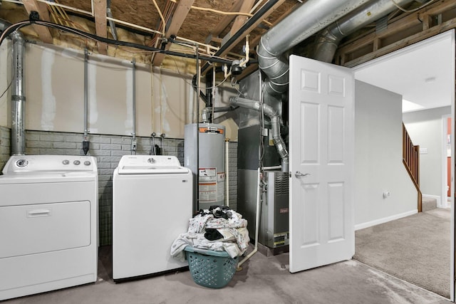 laundry area featuring washing machine and clothes dryer, gas water heater, and laundry area