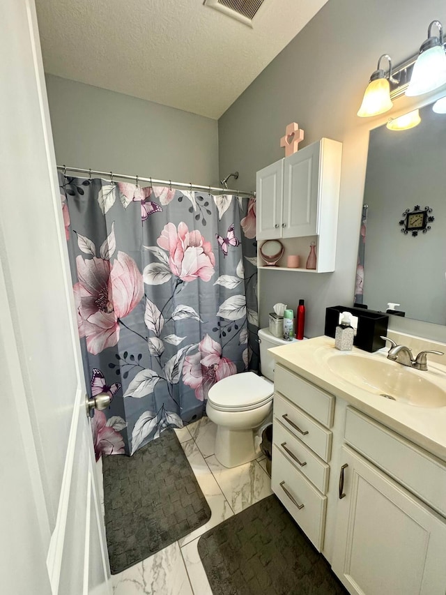 bathroom with visible vents, vanity, toilet, marble finish floor, and a shower with shower curtain