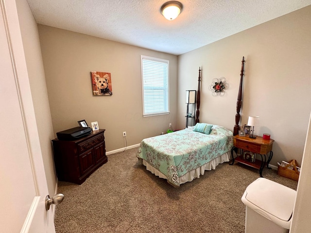 bedroom featuring baseboards, carpet flooring, and a textured ceiling