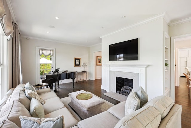 living area featuring crown molding, a fireplace, recessed lighting, and dark wood-type flooring