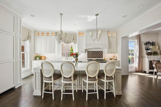 kitchen featuring a kitchen island, crown molding, a chandelier, and tasteful backsplash