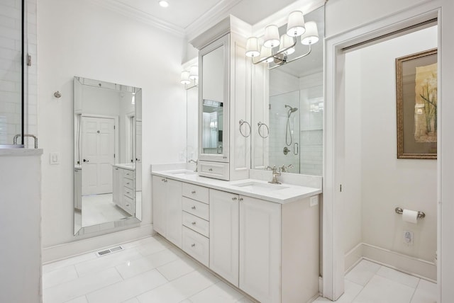 bathroom with a sink, ornamental molding, a shower stall, and visible vents