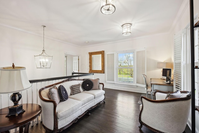 living area with dark wood-style floors, an inviting chandelier, and ornamental molding