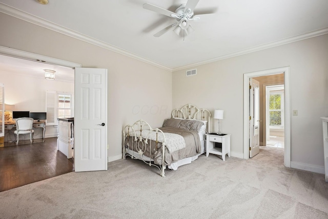 bedroom featuring crown molding, carpet floors, multiple windows, and visible vents