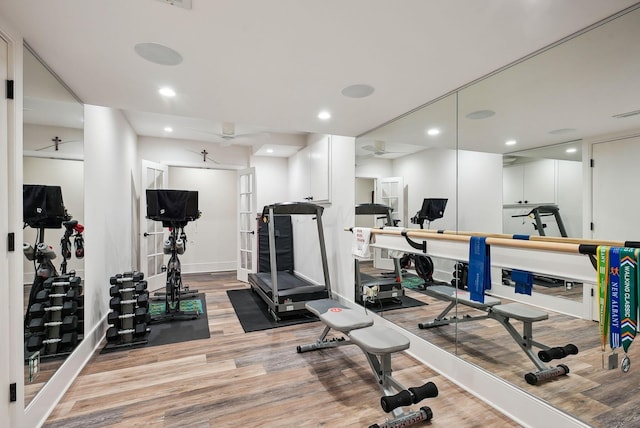 exercise room with recessed lighting and light wood-type flooring