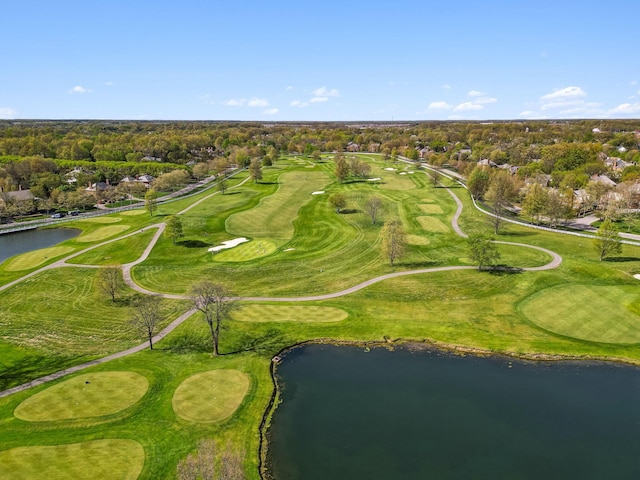drone / aerial view with view of golf course and a water view