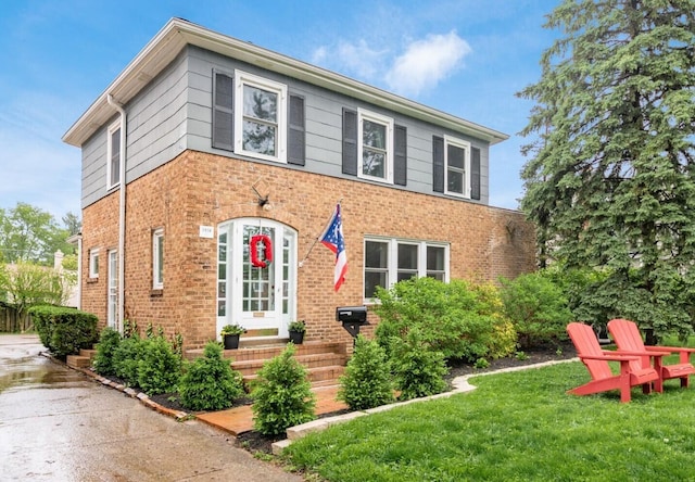 1938 W 5th Ave, Columbus, OH 43212 - view of front facade featuring brick siding and a front lawn