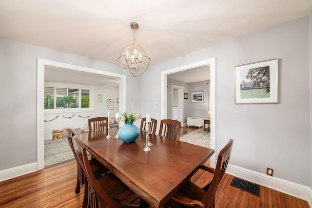 1938 W 5th Ave, Columbus, OH 43212 - dining room featuring a chandelier, light wood-type flooring, and baseboards