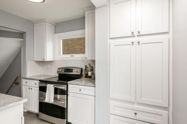 1938 W 5th Ave, Columbus, OH 43212 - kitchen featuring range with two ovens, tasteful backsplash, and white cabinetry