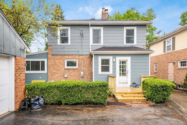 1938 W 5th Ave, Columbus, OH 43212 - view of front facade featuring a chimney, a wooden deck, and brick siding