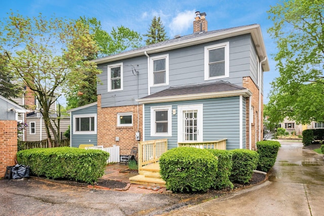 1938 W 5th Ave, Columbus, OH 43212 - view of front of house with a chimney, a wooden deck, and roof with shingles