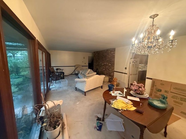 dining room with concrete floors and a notable chandelier