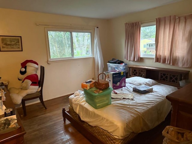 bedroom with baseboards and wood finished floors