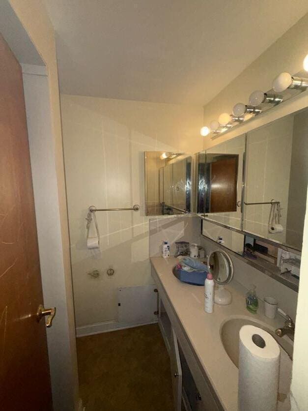 bathroom with tile walls and vanity