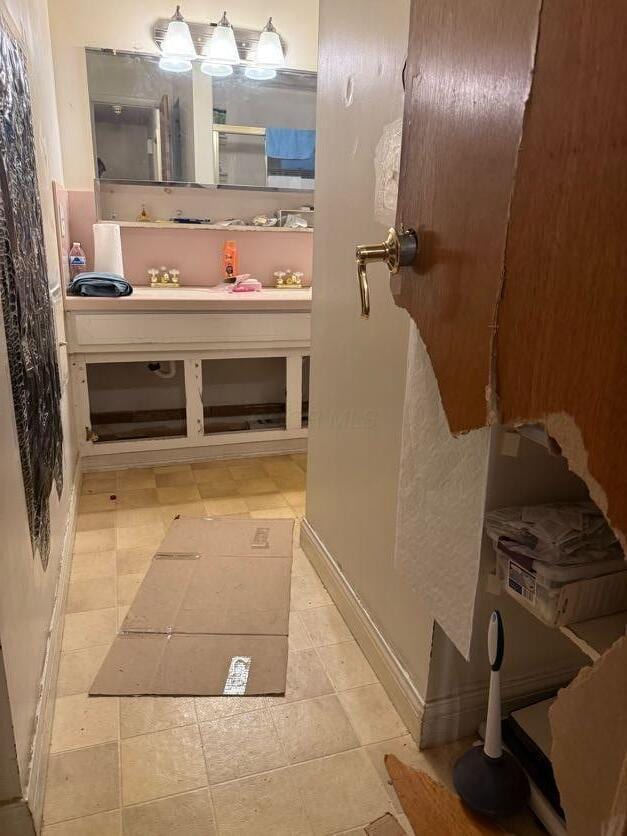bathroom with baseboards and vanity