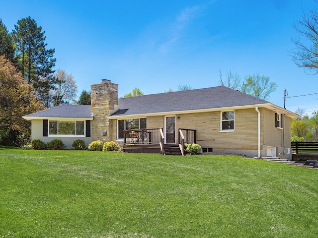 rear view of house featuring a yard, a chimney, and a wooden deck