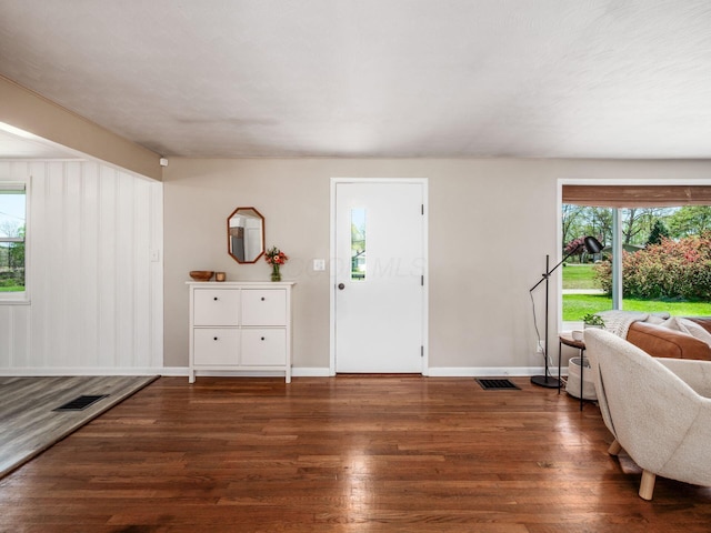 entryway with visible vents, baseboards, wood finished floors, and a healthy amount of sunlight