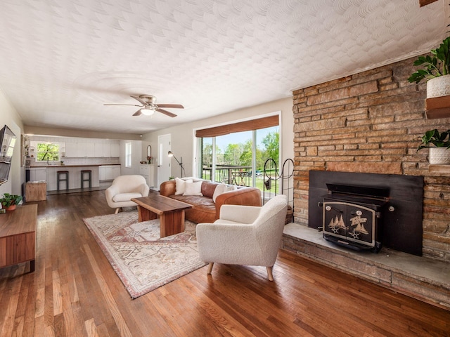 living area featuring a ceiling fan and hardwood / wood-style flooring
