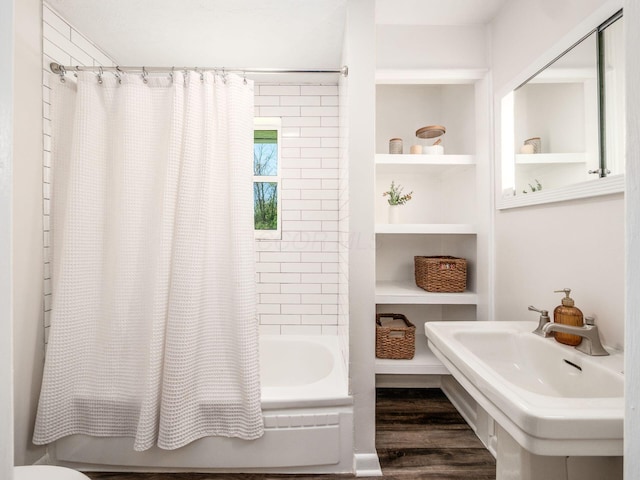 full bath featuring a sink, built in features, shower / bathtub combination with curtain, and wood finished floors