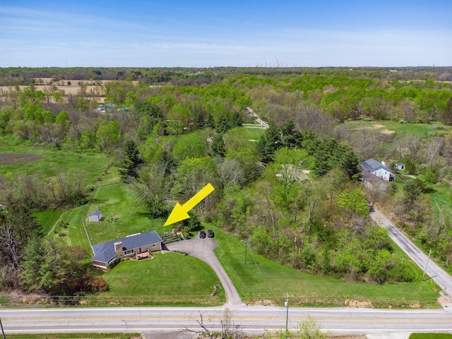 birds eye view of property featuring a wooded view