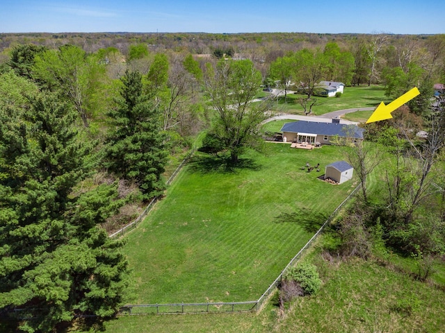 drone / aerial view featuring a wooded view