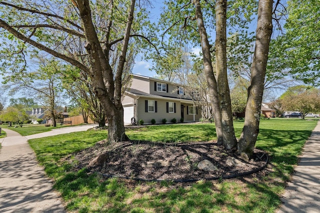 traditional-style home featuring a front lawn