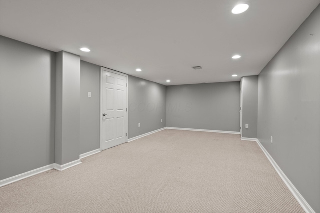 finished basement featuring light colored carpet, recessed lighting, and baseboards