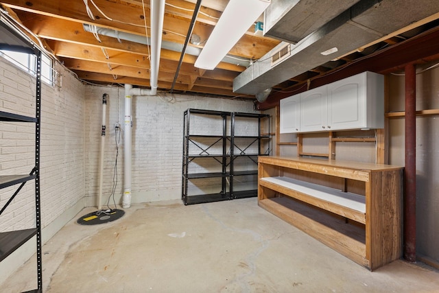 basement featuring brick wall