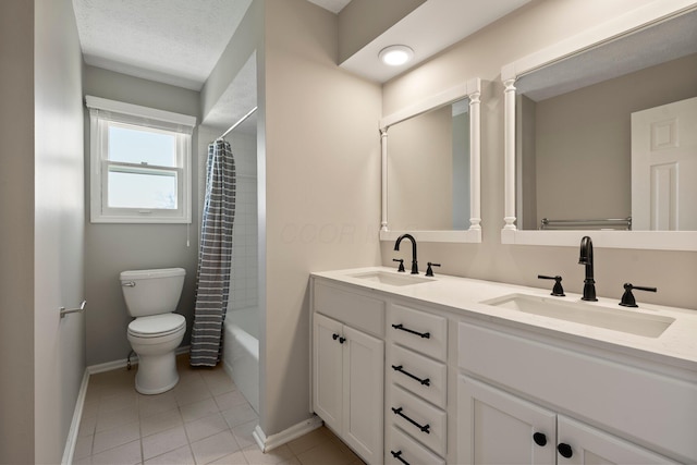 bathroom featuring toilet, baseboards, a sink, and tile patterned flooring