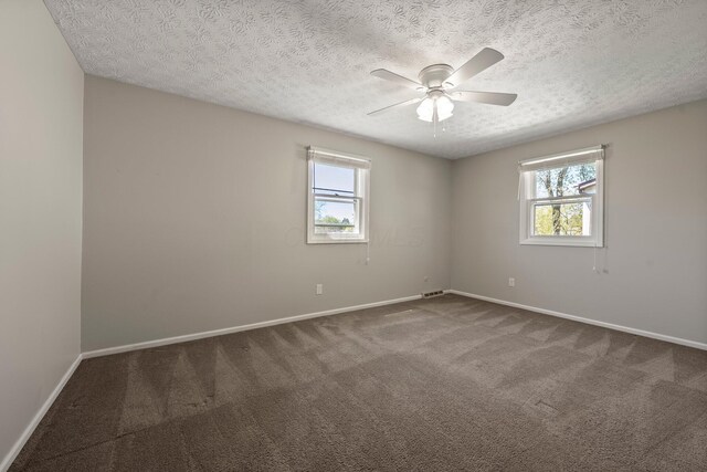 empty room with carpet floors, baseboards, and plenty of natural light