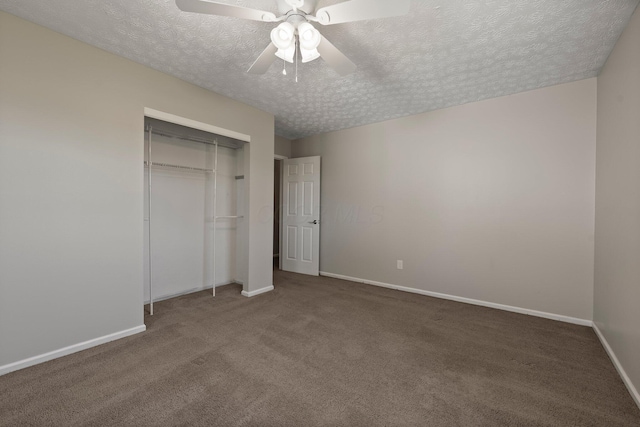unfurnished bedroom featuring carpet flooring, a textured ceiling, baseboards, and a closet